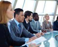 Row of serious business people attending seminar